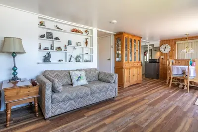 a living room with a couch and a table at Paha Lakefront in Bass Lake