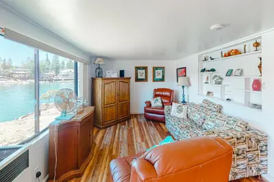 a living room with a couch and a window at Paha Lakefront in Bass Lake