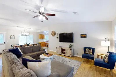 a living room with a couch and a flat screen tv at Pine Place in Oakhurst
