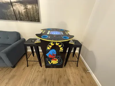 a table in the corner of a room with a couch at Pine Place in Oakhurst