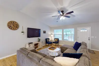a living room with a couch and a tv at Pine Place in Oakhurst