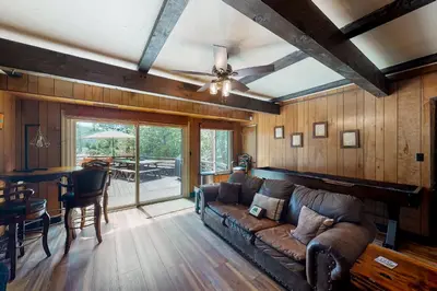 a living room with a couch and a ceiling fan at Twets Lakefront in Bass Lake