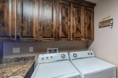a kitchen with wooden cabinets and white appliances at Brickers Lakefront in Bass Lake
