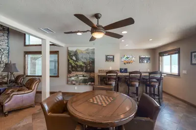 a living room with a table and chairs at Brickers Lakefront in Bass Lake