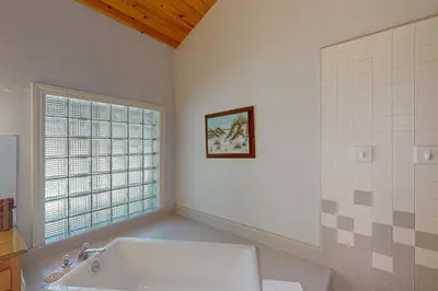 a white bathroom with a tub and a window at Yosemite Nutter Ranch in Mariposa