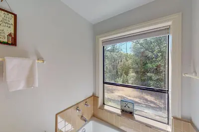 a bathroom with a window and a tub and a sink at Yosemite Nutter Ranch in Mariposa