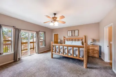 a bedroom with a bed and a ceiling fan at Robinson Shoreline House in Bass Lake