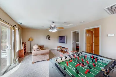 a living room with a pool table at Robinson Shoreline House in Bass Lake