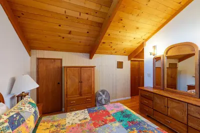 a bedroom with a bed and a wooden ceiling at Peters Lakefront in Bass Lake