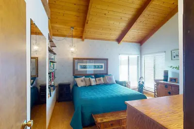 a bedroom with a bed and a wooden ceiling at Peters Lakefront in Bass Lake