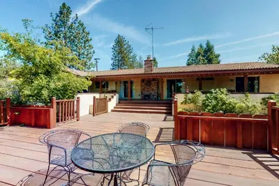 a patio with a table and chairs on a house at Putney Place in North Fork