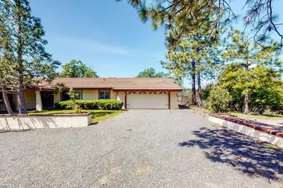a house with a driveway with a garage at Putney Place in North Fork