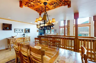 a dining room with a table and chairs at Humphreys Lakefront in Bass Lake