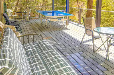a deck with chairs and a table and a table and chairs at Alford Family Lodge in Bass Lake