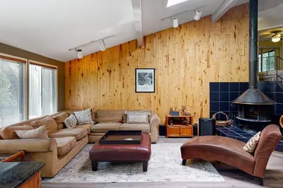 a living room with a couch and a fireplace at Todds Lakefront House in Bass Lake
