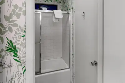 a bathroom with a shower with a glass door at Todds Lakefront House in Bass Lake