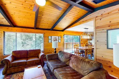a living room with leather couches and a dining room at Yosemite Big Rock Cabin in Fish Camp