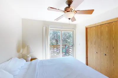 a bedroom with a bed and a ceiling fan at Streiff Lake House in Bass Lake