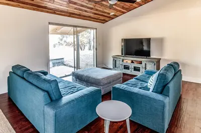 a living room with two blue couches and a tv at Pine Ridge Peak in Oakhurst