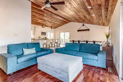 a living room with two blue couches and a table at Pine Ridge Peak in Oakhurst