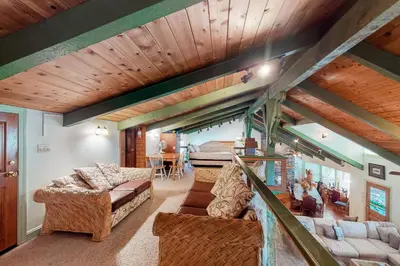 a living room with couches and a wooden ceiling at Knott Lakeview in Bass Lake