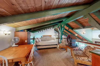 a bedroom with a bed and a wooden ceiling at Knott Lakeview in Bass Lake