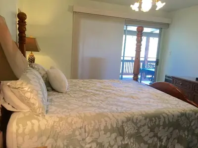 a bedroom with a bed with a view of a balcony at Knott Lakeview in Bass Lake