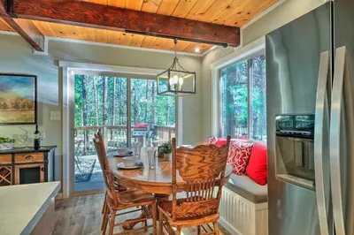a kitchen and dining room with a table and chairs at Game Room and Deck Oso Cozy Cabin in Arnold! in Arnold
