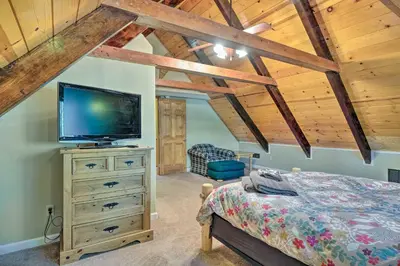 a bedroom with a bed and a tv on a dresser at Game Room and Deck Oso Cozy Cabin in Arnold! in Arnold