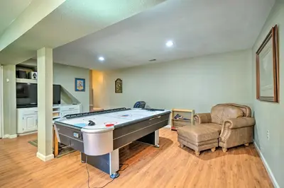 a living room with a pool table and a chair at Game Room and Deck Oso Cozy Cabin in Arnold! in Arnold