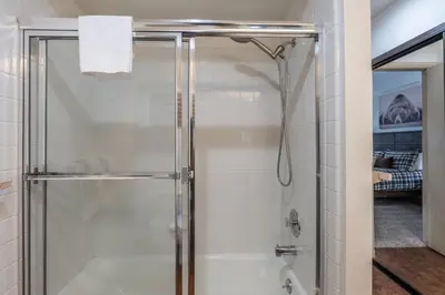 a shower with a glass door in a bathroom at Warm and cozy upgraded 2 bedrm 2 bath single level condo in Snowcreek complex phase IV 563 Sleeps 6 in Mammoth Lakes