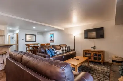 a living room with a couch and a table at Warm and cozy upgraded 2 bedrm 2 bath single level condo in Snowcreek complex phase IV 563 Sleeps 6 in Mammoth Lakes
