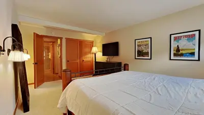 a bedroom with a large bed and a television at Spacious One Bedroom Condo in Mammoth! Free Assigned Parking - Snowbird 107 in Mammoth Lakes