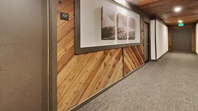 a hallway with wooden floors and a wall with a picture at Spacious One Bedroom Condo in Mammoth! Free Assigned Parking - Snowbird 107 in Mammoth Lakes