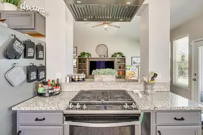 a kitchen with a stove and a counter top at 8 Mi to Dtwn Reno Cozy Sparks Escape with Fireplace in Sparks