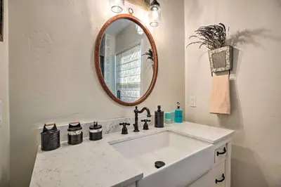 a bathroom with a sink and a mirror at Vintage Bishop House in Downtown with Porch Swing! in Bishop