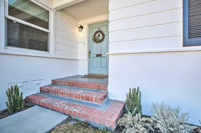 a front door of a house with a set of stairs at Vintage Bishop House in Downtown with Porch Swing! in Bishop