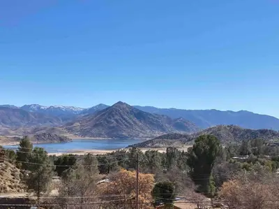 a view of a lake with mountains in the background at Views Views Views! in Wofford Heights