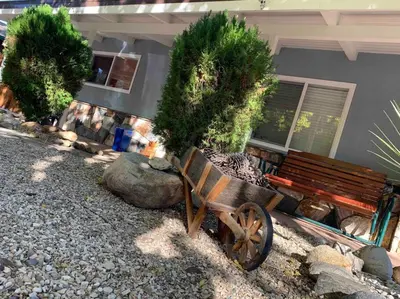 a wooden bench sitting in front of a house at Kernville - walk to River Kern & Downtown in Kernville