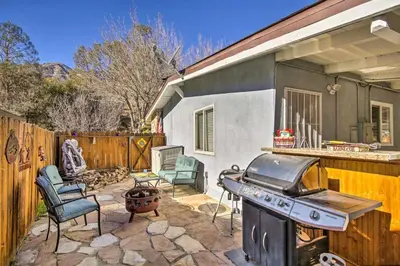 a backyard with a grill and chairs and a house at Kernville - walk to River Kern & Downtown in Kernville