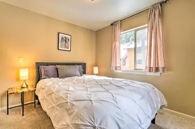 a bedroom with a large bed and a window at Great for Groups Soda Springs Cabin with Deck! in Soda Springs