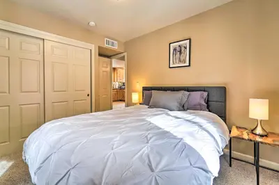 a bedroom with a large white bed and two lamps at Great for Groups Soda Springs Cabin with Deck! in Soda Springs