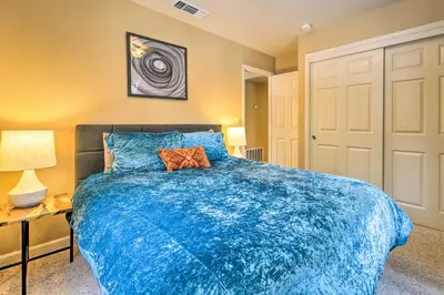 a bedroom with a blue comforter on a bed at Great for Groups Soda Springs Cabin with Deck! in Soda Springs