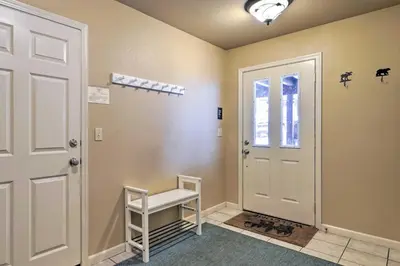 a hallway with a white door and a white stool at Great for Groups Soda Springs Cabin with Deck! in Soda Springs