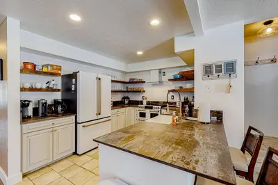 a large kitchen with white cabinets and a counter top at Snowcreek 625 in Mammoth Lakes