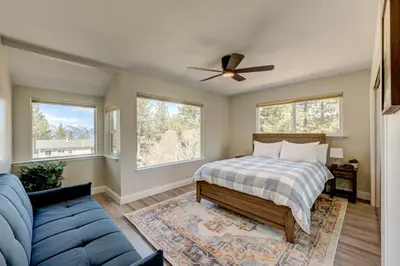 a bedroom with a bed and a couch and windows at Lake Lookout in Stateline