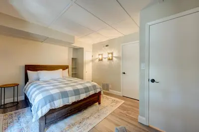 a bedroom with a bed with a checked blanket and a door at Lake Lookout in Stateline