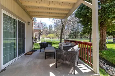 a patio with chairs and tables on a house at Northshore Lakeview Getaway in Bass Lake