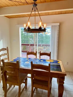 a dining room with a table and chairs and a chandelier at Bearvista in Arnold