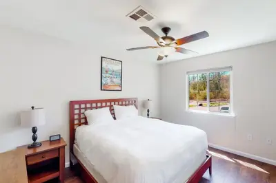 a bedroom with a bed and a ceiling fan at Willard Lake House in Bass Lake